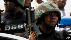 FILE: FILE - In this file photo taken on Thursday, Aug. 8, 2013, Nigerian security forces stand guards during Eid al-Fitr celebration in Maiduguri, Nigeria.