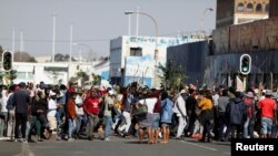 Stick-wielding protesters march through the streets as violence following the jailing of former South African President Jacob Zuma spread to the country's main economic hub in Johannesburg, South Africa, July 11, 2021. 