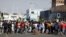 Stick-wielding protesters march through the streets as violence following the jailing of former South African President Jacob Zuma spread to the country's main economic hub in Johannesburg, South Africa, July 11, 2021. 