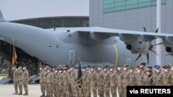 German soldiers line up for the final roll call near an Airbus A400M cargo plane of the German Armed Forces Bundeswehr, after returning from Afghanistan at the airfield in Wunstorf, Germany, June 30, 2021. 