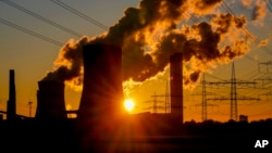 FILE - Steam comes out of chimneys of a coal-fired power station in Niederaussem, Germany, Oct. 24, 2021.