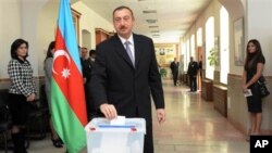 Azerbaijani President Ilham Aliyev casts his vote in Baku, Azerbaijan, Sunday, Nov. 7, 2010.