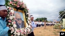 Relatives carry a portrait of former Khmer Rouge's chief ideologist and No. 2 leader, Nuon Chea, during his funeral procession in Pailin in northwestern Phnom Penh, Cambodia, Aug. 9, 2019.