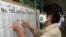 Maryory Vega checks her name on a voting roster during general elections, at a voting center at the Liceo de Moravia school in San Jose, Costa Rica, Feb. 6, 2022. 