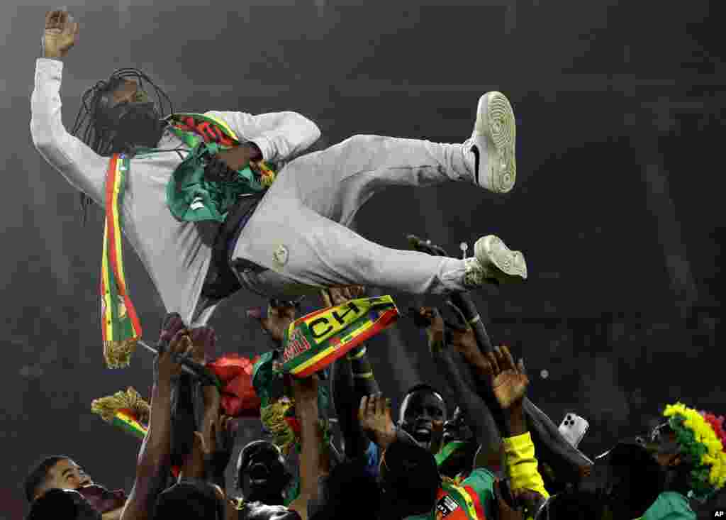 Senegal&#39;s players celebrate with head coach Aliou Cisse after winning the African Cup of Nations 2022 final soccer match between Senegal and Egypt at the Ahmadou Ahidjo stadium in Yaounde, Cameroon, Feb. 6, 2022.