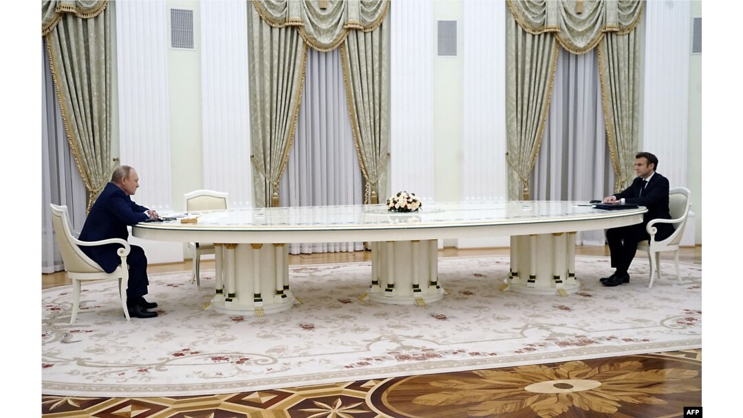 FILE - French President Emmanuel Macron (R) meets with Russian President Vladimir Putin, left, in Moscow on Feb. 7, 2022, for talks in an effort to find common ground on Ukraine and NATO.