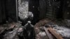 A Ukrainian serviceman moves through the ruins of an industrial compound on a frontline position outside Avdiivka, Donetsk region, eastern Ukraine, Feb. 4, 2022. 