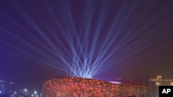 Lights shine during a rehearsal for the opening ceremony of the 2022 Winter Olympics at the National Stadium, known as the Bird's Nest in Beijing, China, Jan. 30, 2022.