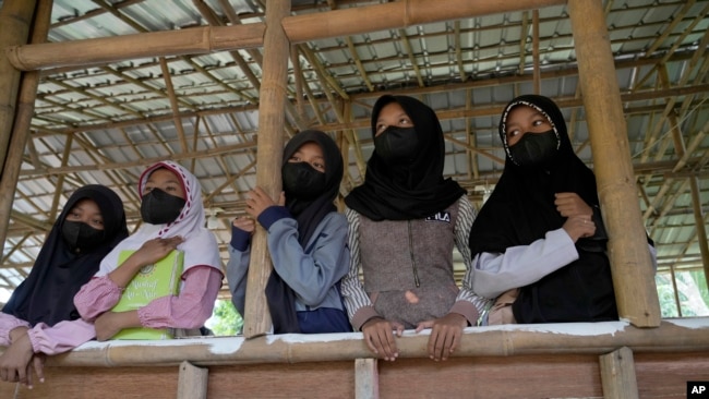 Students wearing face masks as precaution against the coronavirus wait during class at the Nurul Fattah Islamic Boarding School in Tangerang, Indonesia, Monday, Feb. 7, 2022. (AP Photo/Tatan Syuflana)