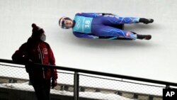 FILE - Emily Sweeney of the United States speeds down the track during a women's luge training session at the 2022 Winter Olympics, Feb. 3, 2022, in the Yanqing district of Beijing.