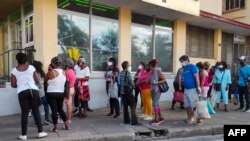 People queue to buy food in Havana, on Feb. 4, 2022.