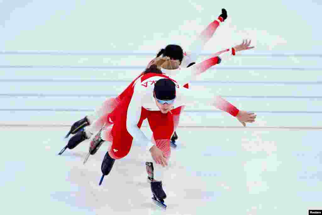 Athletes of Poland warm up before the men&#39;s 5,000-meter speedskating race at the 2022 Winter Olympics in Beijing.