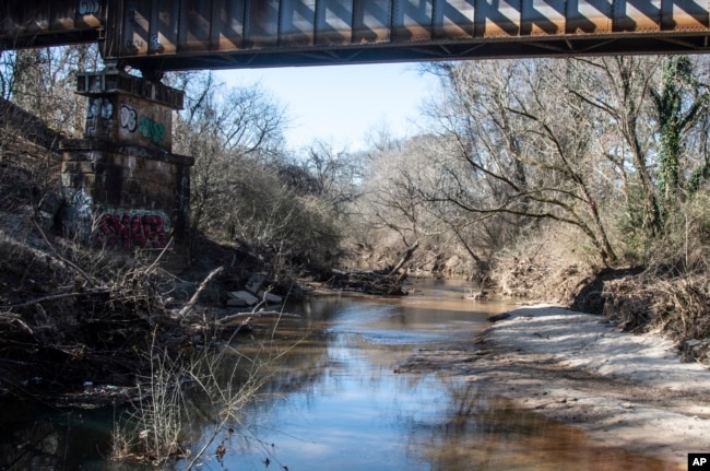 FILE - A portion of South Fork Peachtree Creek is shown on Wednesday, Jan. 26, 2022, in Decatur, Georgia. Jonathon Keats, an American conceptual artist, is in the process of devising a municipal clock to be located in Atlanta which would display time based on the flow rate of local rivers and waterways. (AP Photo/Ron Harris)