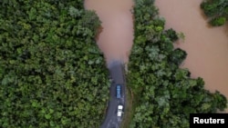 Cars stop before a flooded area, after Cyclone Batsirai made landfall, on a road in Vohiparara, Madagascar, Feb. 6, 2022. 