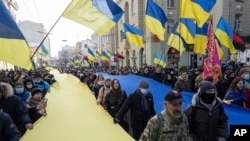 Demonstrators with Ukrainian national flags rally against Russian aggression in the center of Kharkiv, Ukraine's second-largest city, Feb. 5, 2022.