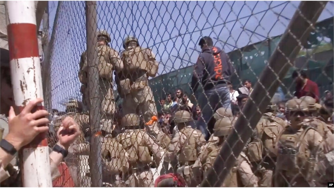 FILE - U.S. Marines are seen at Abbey Gate before a suicide bomber struck outside Hamid Karzai International Airport, in Kabul, Afghanistan, Aug. 26, 2021, in this image from a video released by the Department of Defense.