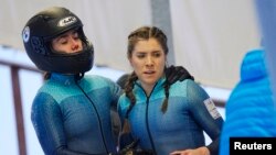 FILE - Australia's Breeana Walker and Kiara Reddingius after crashing during the 2-woman bobsleigh in Bobsleigh & Skeleton World Cup, Latvia, Jan. 2, 2022. 