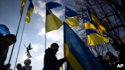 Demonstrators with Ukrainian national flags rally against Russian aggression in the center of Kharkiv, Ukraine's second-largest city, Feb. 5, 2022.