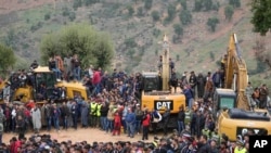 FILE: Residents watch civil defense workers and local authorities work to rescue a boy who fell into a well in Ighran, Morocco, Feb. 4, 2022. 