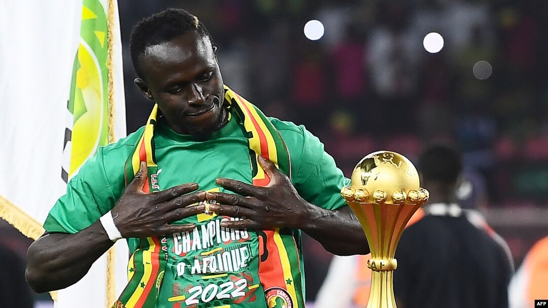 Senegal's forward Sadio Mane looks at the trophy prior to the ceremony after winning after the Africa Cup of Nations (CAN) 2021 final football match between Senegal and Egypt at Stade d'Olembe in Yaounde, Cameroon, on Feb. 6, 2022.