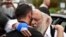 Rabbi Yisroel Goldstein, right, is hugged as he leaves a news conference at the Chabad of Poway synagogue, Sunday, April 28, 2019, in Poway, California. (AP Photo/Denis Poroy)