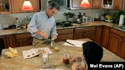 This father in New Jersey fixes dinner for the family, October 2009. It might be a good idea (AP Photo/Mel Evans)