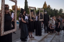 Schoolteachers dressed in black take part in a demonstration against a new protest law in Athens,  July 9, 2020.