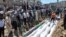 People gather at a mass burial for the victims purportedly killed during an artillery barrage from Syrian forces in Houla in this handout image provided by Shaam News Network, May 26, 2012.
