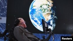 FILE - Physicist Stephen Hawking sits on stage during an announcement of the Starshot initiative with investor Yuri Milner in New York, April 12, 2016. A partnership was announced this week with the European Southern Observatory, which will use one of their telescopes to hunt for inhabitable planets. 