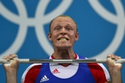 FILE - Russia's Andrey Demanov competes during the men's 94kg group A weightlifting event of the London 2012 Olympic Games at The Excel Centre in London on August 4, 2012.