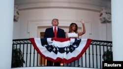 President Donald Trump and first lady Melania Trump stand on the Truman Balcony of the White House as they watch a fireworks display during a 'Salute to America' event, July 4, 2020, in Washington.