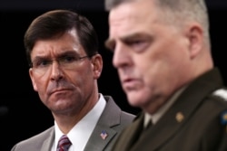 Defense Secretary Mark Esper, left, listens as Chairman of the Joint Chiefs of Staff Army Gen. Mark Milley, right, speaks during a briefing at the Pentagon in Washington, March 2, 2020.