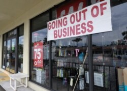 FILE - A store front with a "Going Out of Business" sign is seen in North Miami Beach, Florida, April 30, 2020.