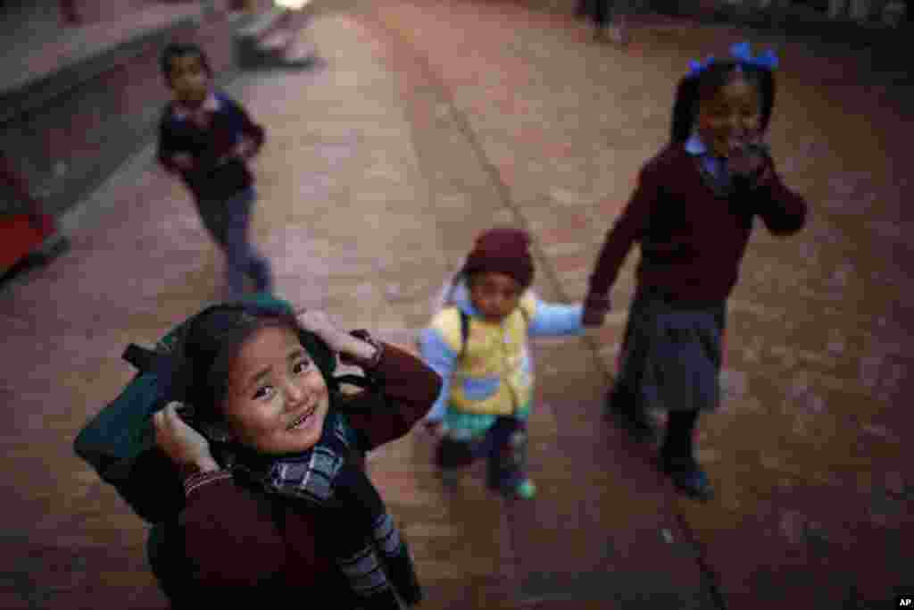 Nepalese children walk home from school at Bhaktapur. Bhaktapur, also known as the city of devotees, is an ancient city and part of the Katmandu valley, which holds the status of a World Heritage Site.