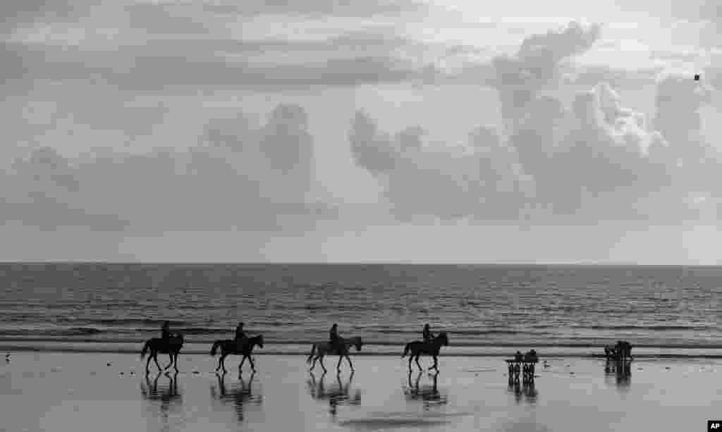 Policemen on horse backs patrol on the Arabian Sea coast after the end of the 10-day long Ganesh Chaturthi festival in Mumbai, India.