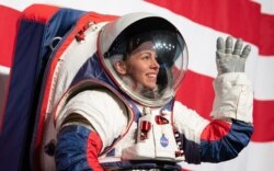 Kristine Davis, a spacesuit engineer at the Johnson Space Center, wears a ground prototype of NASA’s new Exploration Extravehicular Mobility Unit, during a demonstration of the suit, Oct. 15, 2019 at NASA Headquarters in Washington. (NASA/Joe Kowsky)