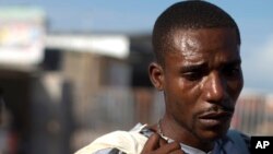 Tears stain the face of Jean Thezon, 26, after he was deported from the Dominican Republic to Haiti along with girlfriend Milene Monime, 16, and their two-month-old son, at the border crossing in Malpasse, Haiti, June 17, 2015. 