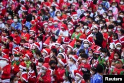 Elephants in Santa Claus costumes visit a school in Ayutthaya