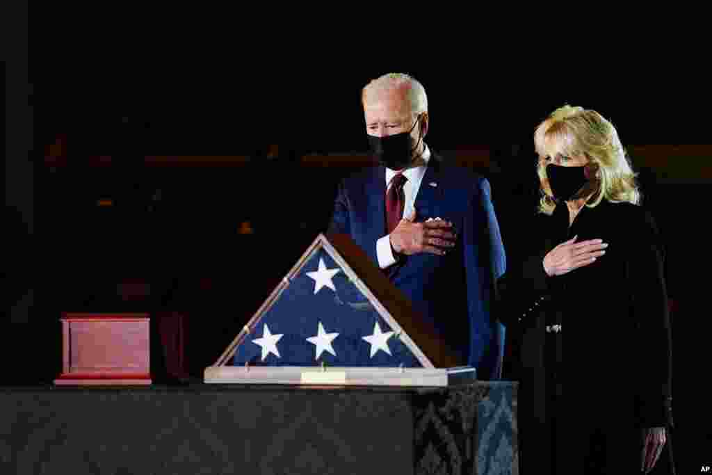 President Joe Biden and first lady Jill Biden pay their respects to the late U.S. Capitol Police officer Brian Sicknick as an urn with his cremated remains lies in honor on a black-draped table at center of Capitol Rotunda in Washington, Feb. 2, 2021.