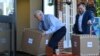 Vice President Mike Pence unloads boxes of supplies at Woodbine Rehabilitation and Healthcare Center in Alexandria,Va., May 7, 2020. 