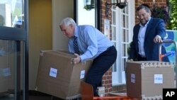 Vice President Mike Pence unloads boxes of supplies at Woodbine Rehabilitation and Healthcare Center in Alexandria,Va., May 7, 2020. 