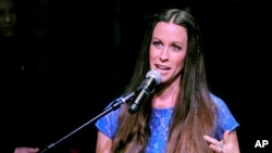 Singer Alanis Morissette addresses the audience at her RockWalk induction ceremony at Guitar Center on Tuesday, Aug. 21, 2012, in Los Angeles.