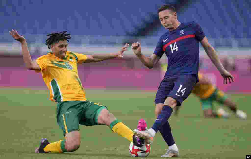France&#39;s FlorianThauvin, right, and Luke Fleurs of South Africa battle for the ball during a men&#39;s soccer match at the 2020 Summer Olympics, Sunday, July 25, 2021, in Saitama, Japan. (AP Photo/Martin Mejia)