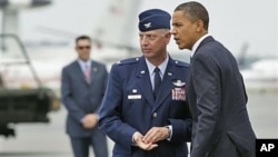 President Barack Obama is greeted by Col. Mark Camerer, the 436th Airlift Wing Commander, upon his arrival at Dover Air Force Base, Dover, Delaware, August 9, 2011