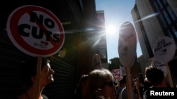 FILE - Demonstrators protest outside the Daily Mail headquarters in London, Oct. 6, 2013. 