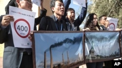 FILE - Activists stage a protest against man-made emissions of carbon dioxide and other global-warming gases, at the COP22 climate change conference in Marrakech, Nov 16, 2016.