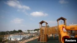 Children climb on a playground in a Jewish settlement in the Etzion settlement bloc, near Bethlehem.