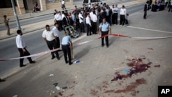 FILE - Israeli police officers inspect the scene of a stabbing attack in Beit Shemesh, central Israel, Oct. 22, 2015. A five-month outburst of violence has killed 27 Israelis and 162 Palestinians.