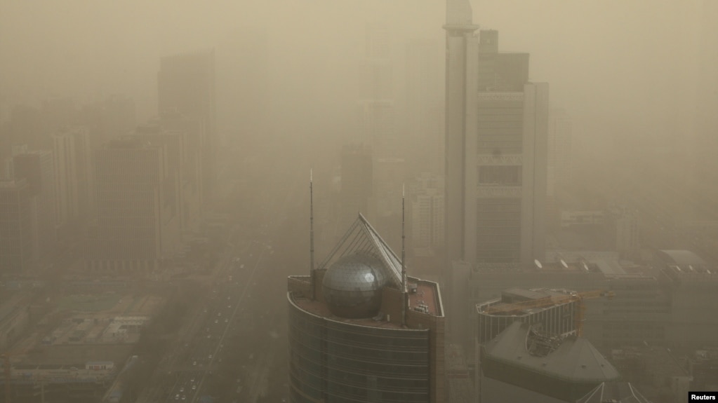 FILE - A general view shows the skyscrapers Beijing, China, shrouded in smog, March 15, 2021. 