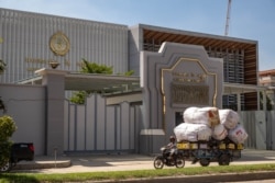 FILE - A man is transporting goods on a motorbike, passing the National Bank of Cambodia in Phnom Penh, Cambodia, on June 3, 2020. (Malis Tum/VOA Khmer)